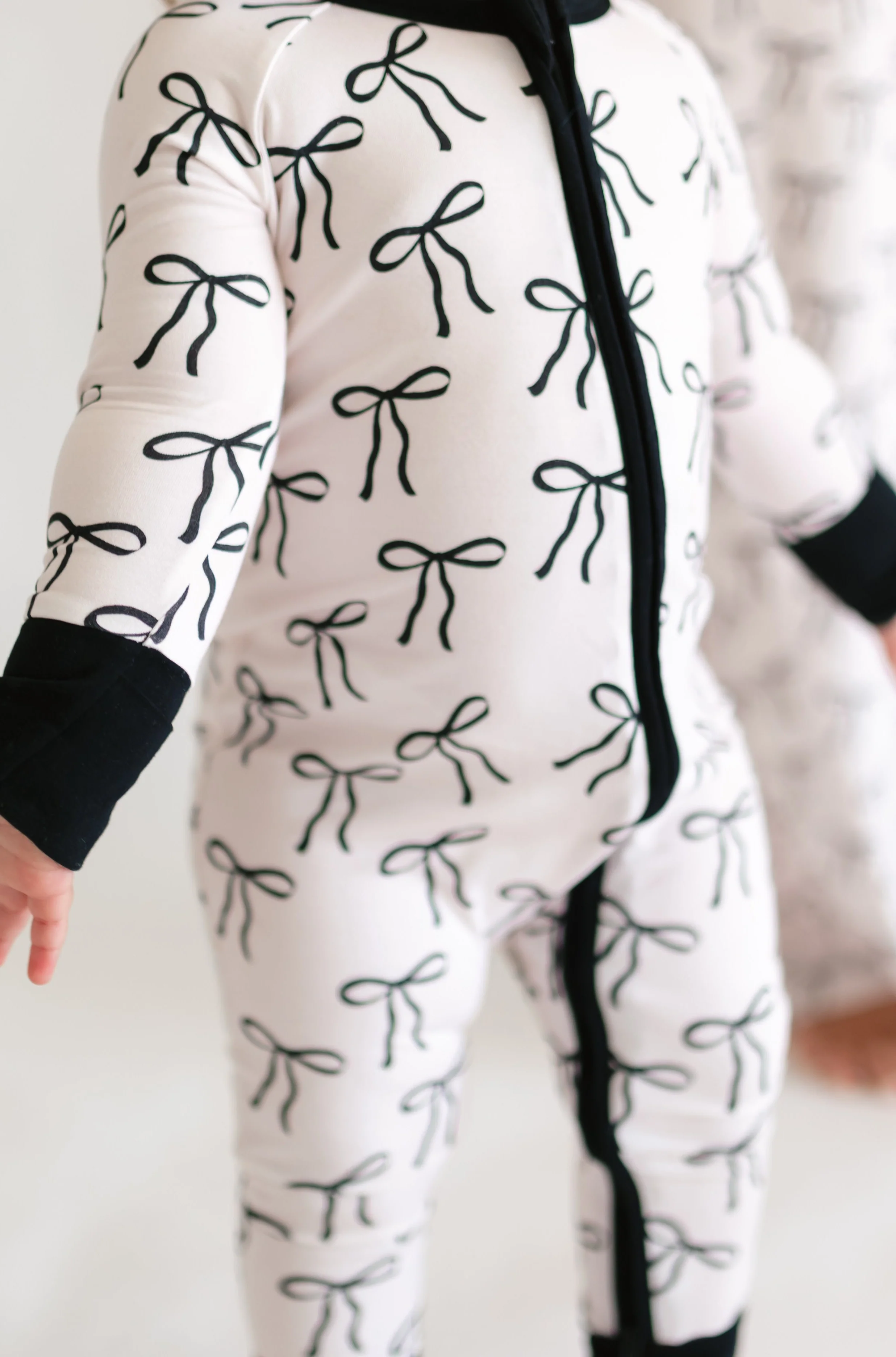 Infant Romper in Black Bows - Image 2